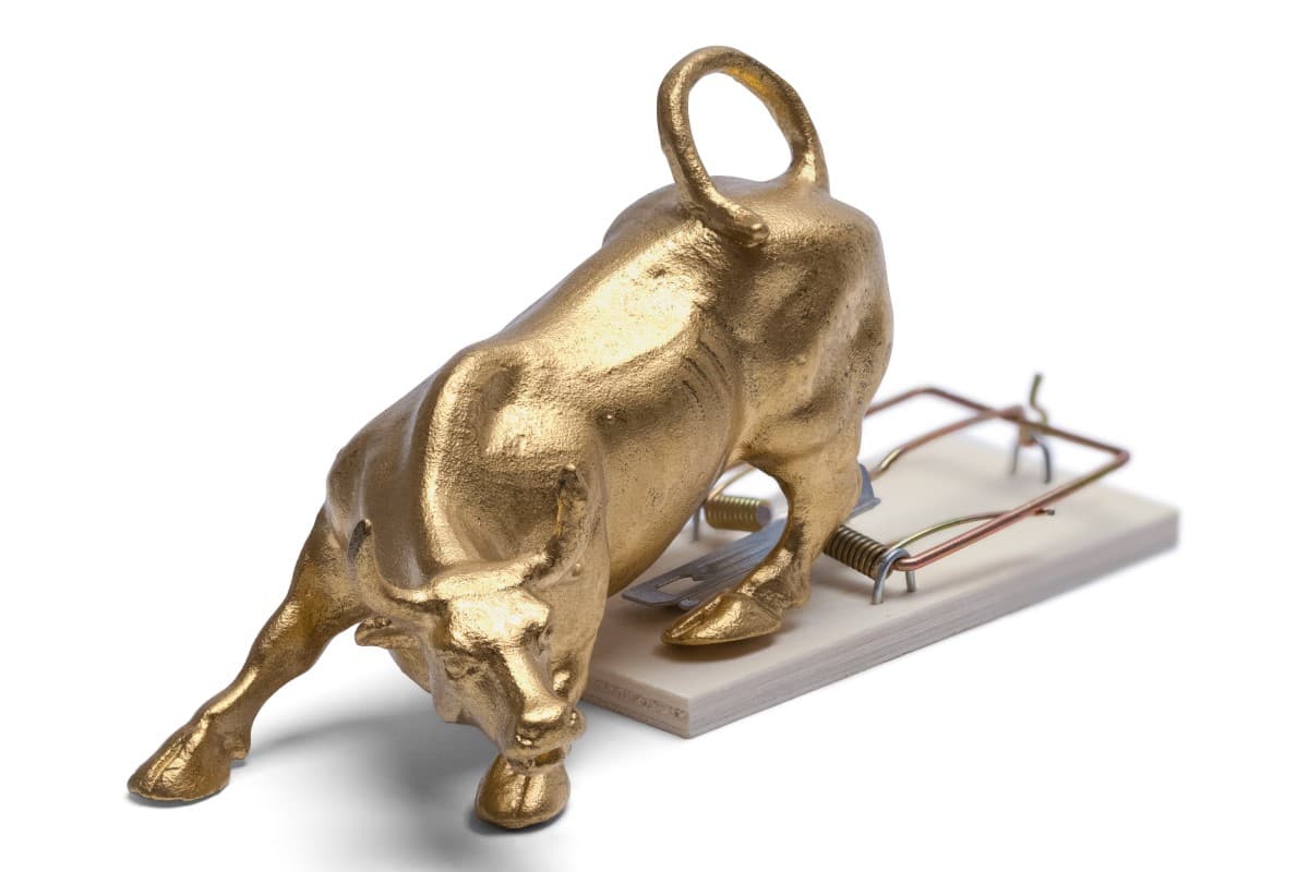 brass bull on trap isolated white