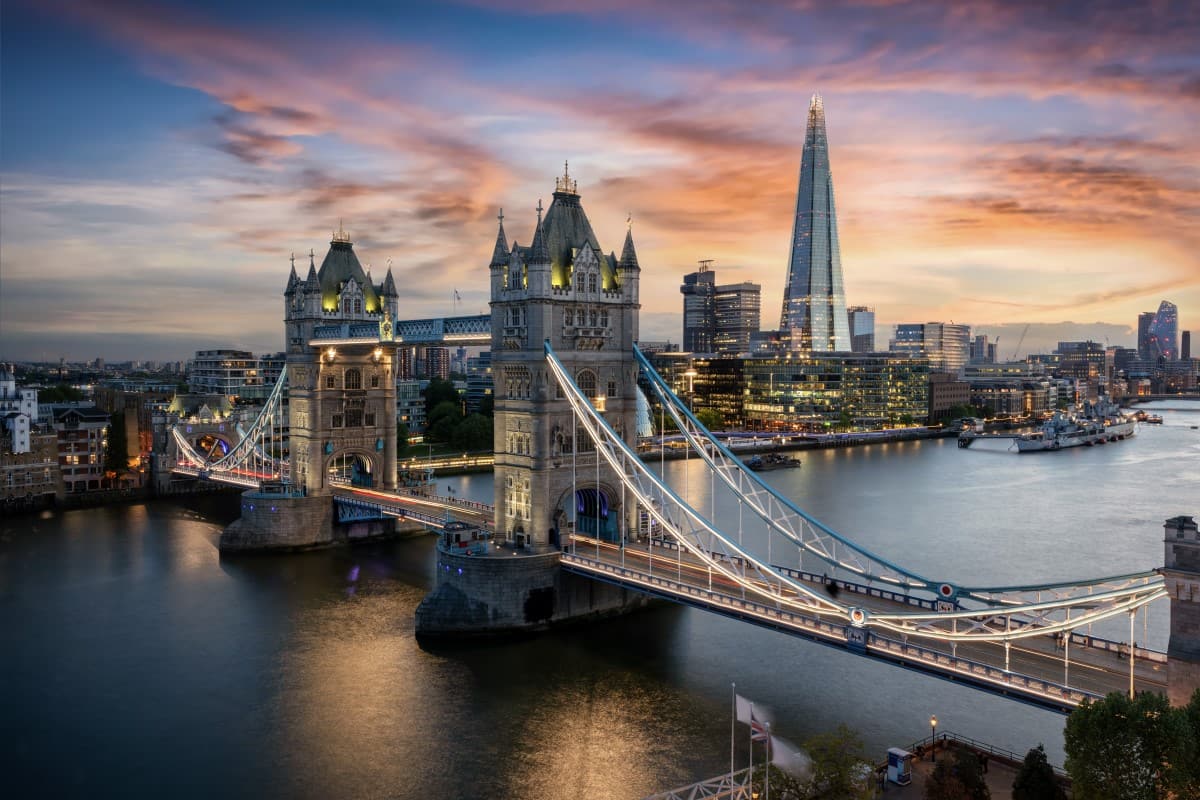 Aerial view to the illuminated Tower Bridge and skyline of London, UK