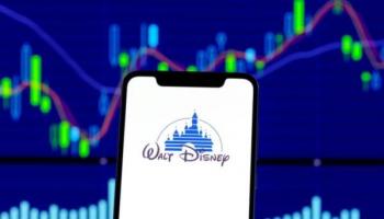 Disney logo in front of stock charts